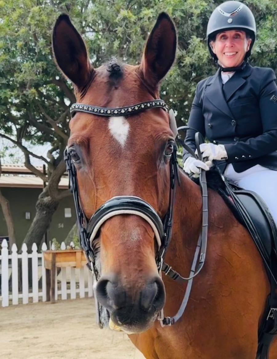 Kristie Bigham, Equine Specialist at Center X Equine Therapy, on a bay dressage horse